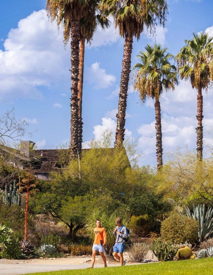 Students walk to class in front of the Grove House